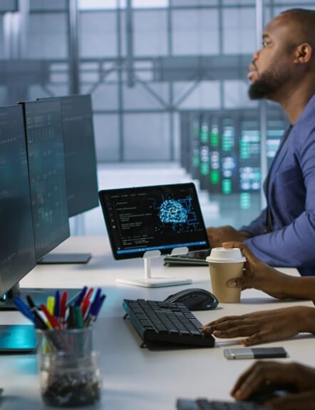 Admin in data center drinking coffee and implementing AI predictive maintenance systems. Server hub worker enjoying hot beverage, using artificial intelligence to identify hardware failures, camera A
